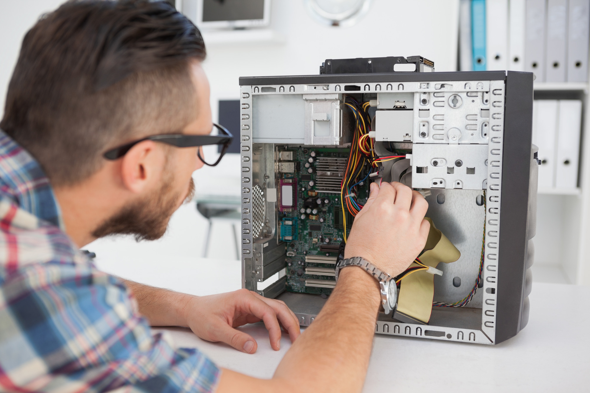 Computer technician working on a broken console.